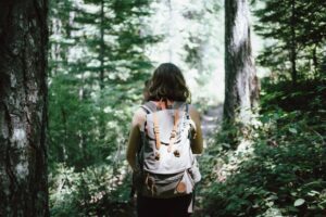 Hiker with a backpack walking in the woods near Antioch, TN - HND Realty